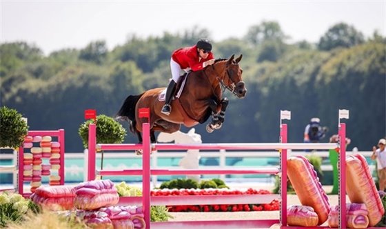 Photo of Karl Cook and his equine partner Caracole jumping