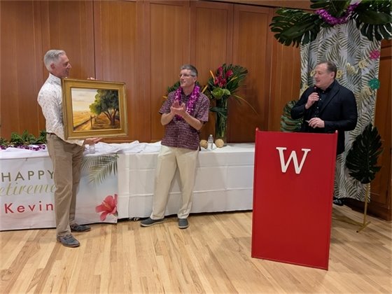 Photo of Kevin at his Retirement Party Receiving Gift